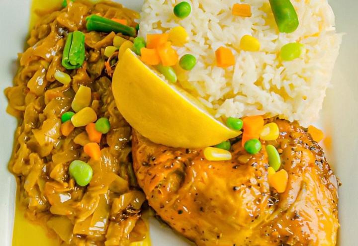 Poulet grillé avec sa sauce citron-oignons servi avec riz blanc.